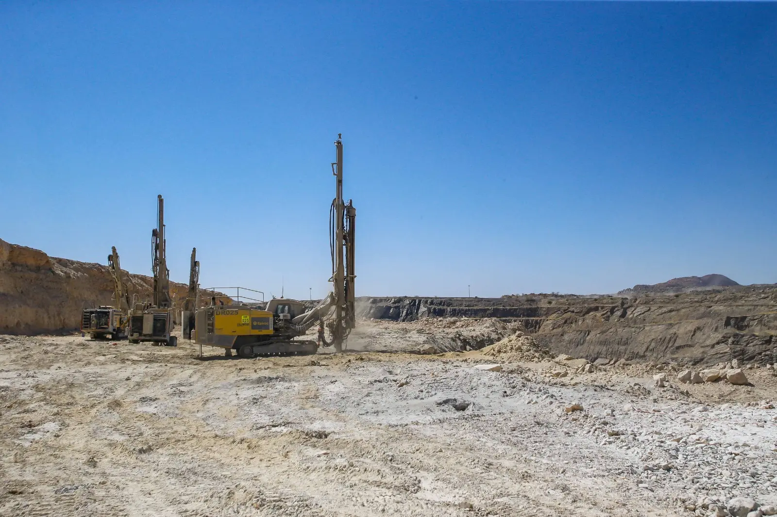 Drilling rigs on a mine bench